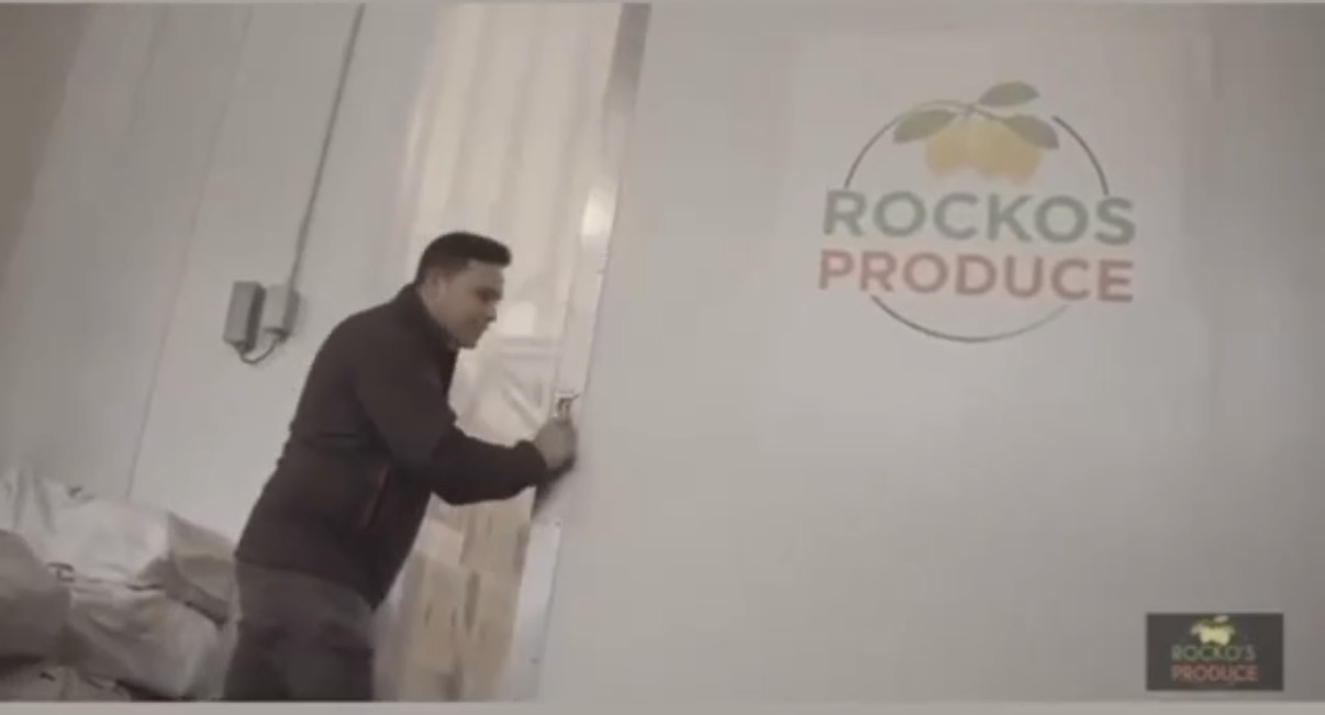 A moment at Rocko’s Produce warehouse, with the company logo on the wall